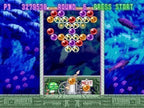 Eine Spielszene von Bust-A-Move 3 DX auf der PS1 zeigt bunte Blasen, einen Blasenwerfer und den grünen Drachen Bub.