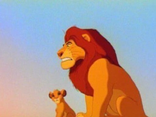 Mufasa und der junge Simba stehen vor einem hellblauen Himmel, Mufasa blickt ernst zur Seite.