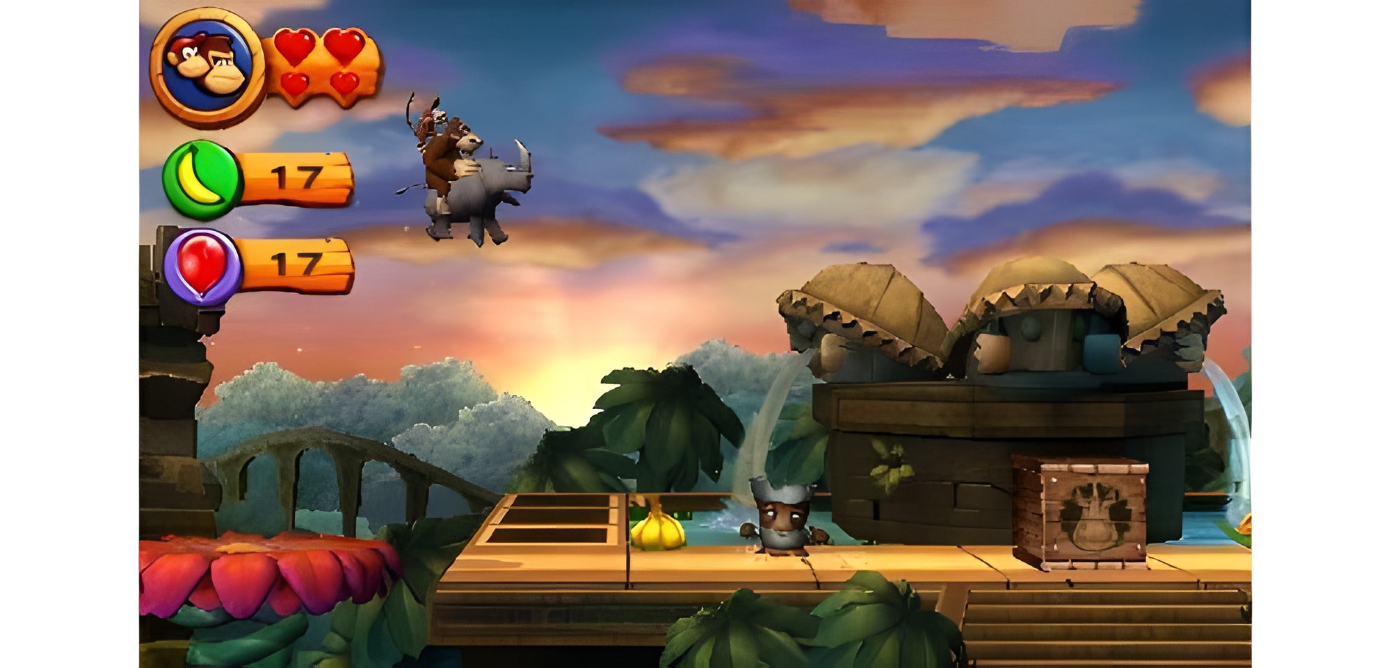 Donkey Kong reitet in Donkey Kong Country - Returns 3D für Nintendo 3DS auf einem Nashorn in den Sonnenuntergang.