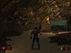 Duke Nukem im Cowboy-Outfit steht in einer Höhle vor einem Gegner und einem Haufen schwarzer Steine.