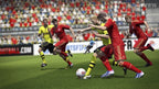 In Fifa 14 kämpfen Fussballer in roten und gelben Trikots um den Ball vor einer Zuschauerkulisse.
