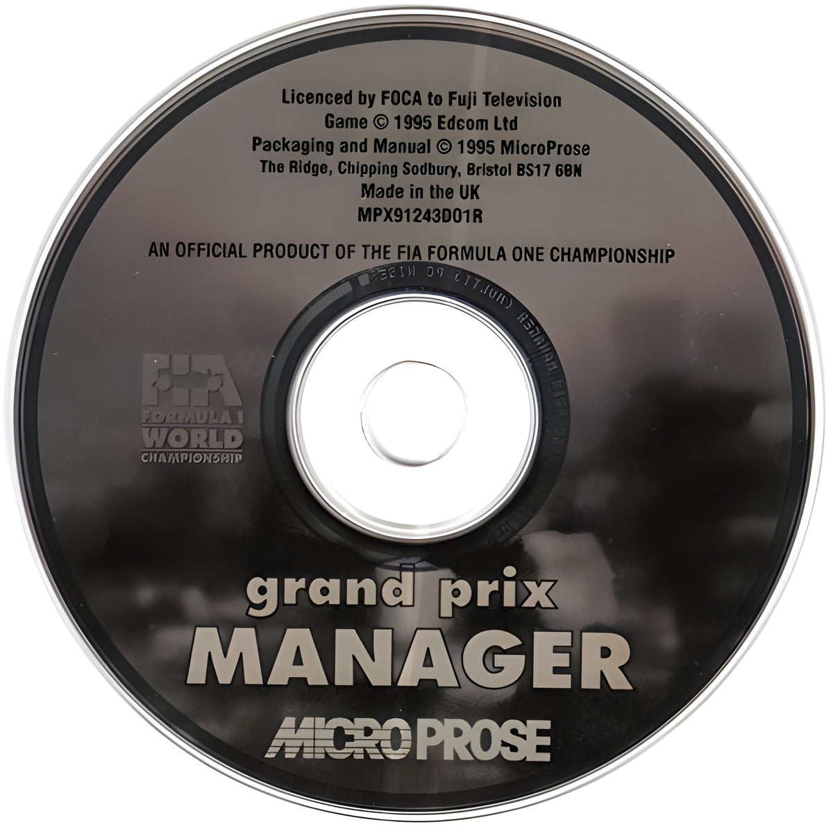 Der Datenträger von Grand Prix Manager ist eine CD-ROM mit dem Titel und dem MicroProse-Logo.