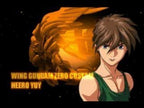 Ein Screenshot zeigt den Charakter Heero Yuy mit einem goldenen Flügel-Logo im Hintergrund.