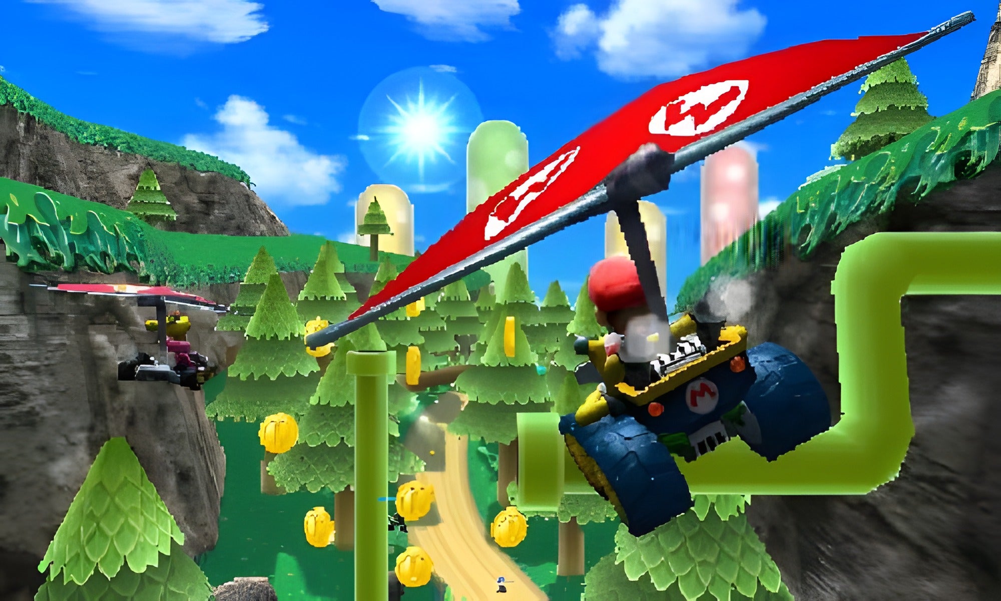 Ein Fahrer mit Gleiter fliegt in Mario Kart 7 für Nintendo 3DS über eine waldige Strecke mit Münzen.