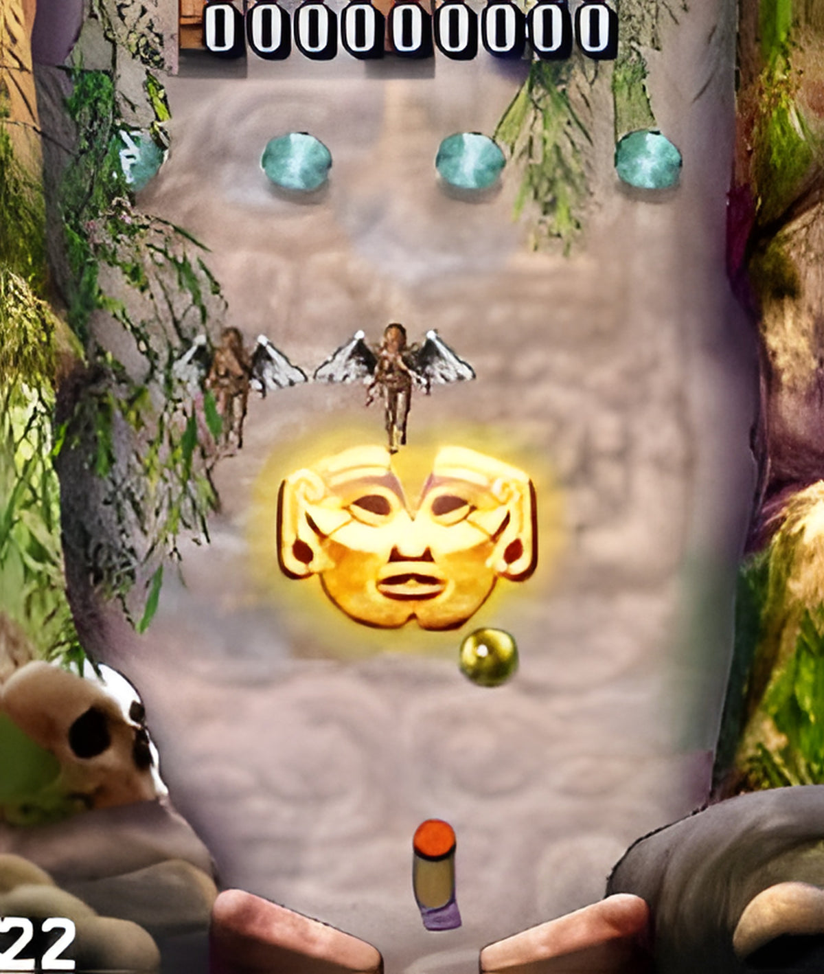 Mile High Pinball zeigt einen Pinball-Tisch mit einer goldenen Maske und zwei geflügelten Figuren.