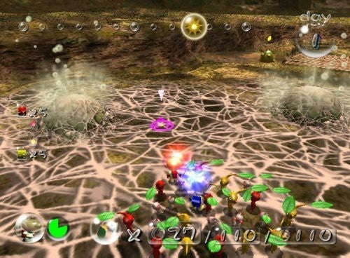 Pikmin in verschiedenen Farben kämpfen auf einem Spinnennetz, umgeben von zwei großen Kokons.
