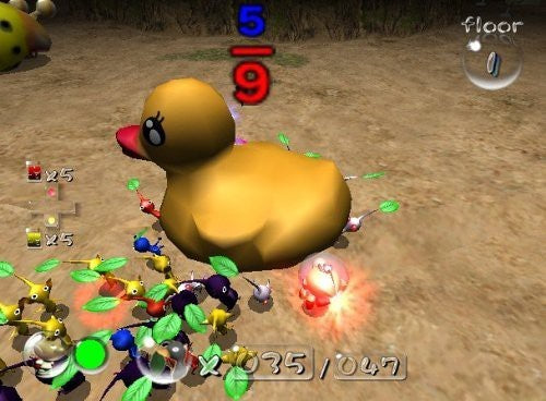 Zahlreiche Pikmin in verschiedenen Farben tragen gemeinsam eine große gelbe Quietscheente über den Boden.