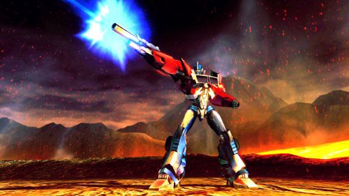 Optimus Prime schießt mit einem blauen Energiestrahl aus seiner Waffe in einer vulkanischen Landschaft.