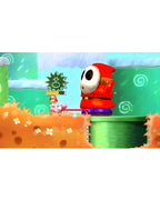 In Yoshis New Island reitet Baby Mario auf einem rosa Yoshi und trifft auf einen großen Shy Guy.